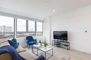 a living room with a couch and a tv at Central 2BR Urban Haven Rooftop Terrace in Bracknell