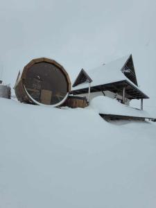 a house covered in snow in front at Osada pod Giewontem in Czerwienne