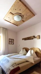 Schlafzimmer mit einem Bett mit Holzdecke in der Unterkunft Casa Zebrusius - Zebrusius's App in Valfurva