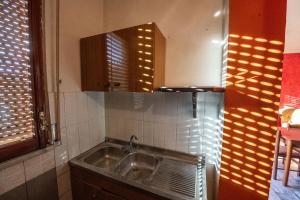 a kitchen with a sink and a mirror at La Vecchia Cascina in Atena Lucana