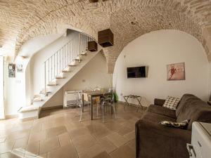 a living room with a couch and a table and stairs at Martine Dimore Storiche di Puglia in Martina Franca
