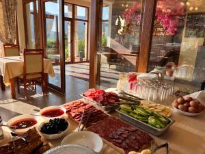 a buffet of food on a table in a restaurant at ArdoVel Park Hotel in Velingrad