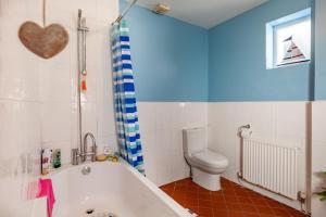 ein Badezimmer mit Badewanne und Toilette in der Unterkunft Family Home with Bunk Beds, Courtyard, TV & Beach in Pembrokeshire + 14 Fotos