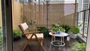 a patio with a table and a chair on a balcony at JB Minato Garden in Hai Phong +16 photos