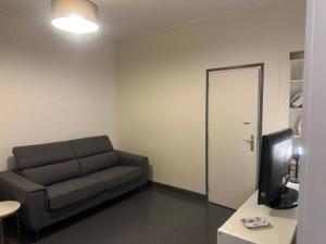 a living room with a couch and a television at Chic studio near chatelet les halles in Paris