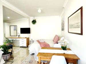 a bedroom with a bed and a desk at Bayside Bliss Studio Apartment in Summerstrand