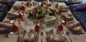 a table with plates and vases on top of it at Riad Les Idrissides in Fez