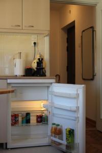 a refrigerator with its door open in a kitchen at Cozy with parking in Zemun