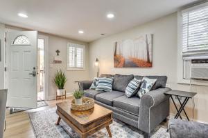 a living room with a couch and a table at Cozy Jacksonville Cottage, Walkable Location! in Jacksonville