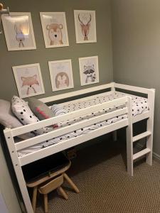 a white bunk bed in a room with pictures on the wall at The Loft in Henley in Arden