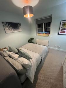 a bedroom with a bed and a window at The Loft in Henley in Arden