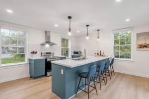 a kitchen with a blue island with bar stools at Lakeside Bliss Breathtaking View in Port Hope
