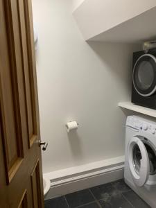 a laundry room with a washer and dryer at Cosy spacious master room. in London