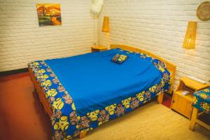 um quarto com uma cama azul num quarto em Room in Guest room - Isange Paradise Resort em Ruhengeri