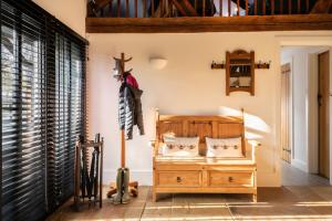 a room with a bed and a wooden dresser at The Cart House in Southampton