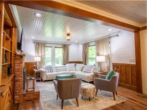 a living room with a couch and chairs at The Farmhouse at Doe Creek in Blowing Rock