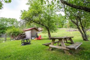 a picnic table and a playground in a field at The Farmhouse at Doe Creek in Blowing Rock +31 photos
