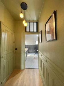 a hallway with a room with a table and a door at Duplex de caractère 50 m² in Moulins