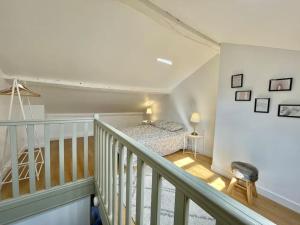 a bedroom with a bed in a stair case at Duplex de caractère 50 m² in Moulins
