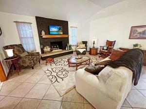 a living room with a couch and a fireplace at Cozy house centrally located close to everything in NWA in Springdale