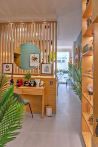 a room with a desk and a room with plants at Napoli Suite Station in Naples