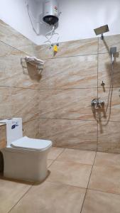 a bathroom with a toilet and a camera on a wall at The Royal Island in Munroe Island