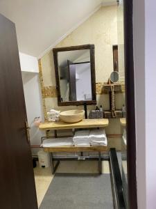 a bathroom with a sink and a mirror at Bob’house in Vulcan +30 photos