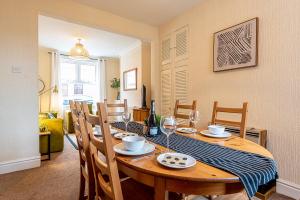 a dining room with a wooden table and chairs at 2 bed, up to 6 guests near Chester City Centre in Chester