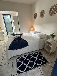 a bedroom with a large bed and a rug at Cantinho da Vesperata - Centro histórico de Diamantina in Diamantina