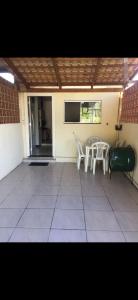 un patio con sillas, una mesa y una ventana en Casa1, en Itapema 3 fotos más