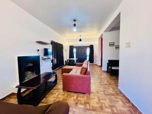 a living room with a couch and a fireplace at Teyt Castle in Ooty