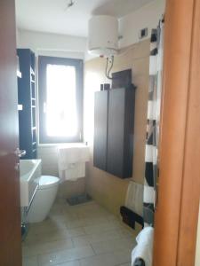 a bathroom with a toilet and a sink and a window at Borgo Antico Santa Lucia in Potenza