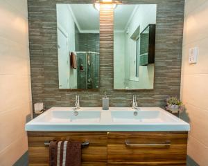 a bathroom with a white sink and a mirror at Sea View apartment on Promenade S1 in Sliema