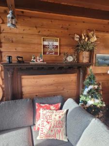- un salon avec un canapé et un arbre de Noël dans l'établissement Le petit chalet sur le lac, à Sainte-Marguerite