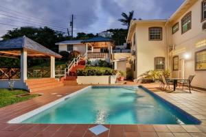 a swimming pool in front of a house at Newly renovated 3-bed spacious family home - Villa Decaj home in Cap Estate