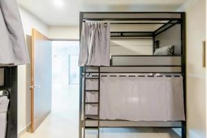 een slaapkamer met een stapelbed en witte gordijnen bij Hostel Mixed Room in Mexico-Stad