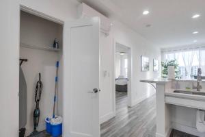 a white kitchen with a sink and a counter at Park Blvd Paradise 303 king bed With a private Spa in San Diego