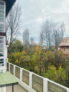 a balcony of a house with a view of a garden at Feather Stays - 4 BHK Apartment in a Villa in Srinagar