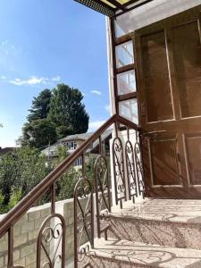 a staircase with a large wooden door on a house at Feather Stays - 4 BHK Apartment in a Villa in Srinagar