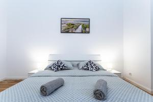 a bedroom with a blue bed with pillows at Cozy apartment in the heart of Prague in Prague