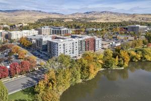 an aerial view of a city with a river and buildings at Boho-Luxe Studio - Pink Accents & Mountain Calm in Boise