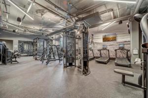 a gym with several treadmills and machines at Boho-Luxe Studio - Pink Accents & Mountain Calm in Boise