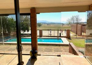 a view of a swimming pool from the porch of a house at Mission House in Howick