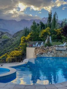 a swimming pool with a view of the mountains at El Carmelo Mountain Lodge in Potrerillos