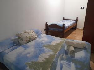 a bedroom with a bed with a roll on it at Frontera Apart in Puerto Iguazú