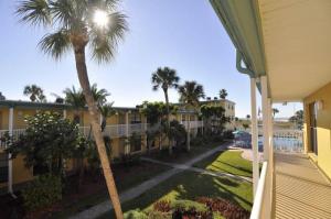 a view of a house with palm trees and a street at Treasure Island Beach Club 727-360-7096 in St Pete Beach