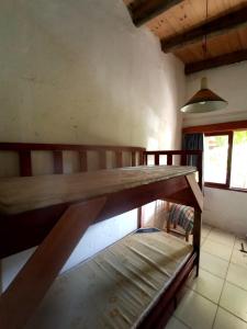 Litera de madera grande en una habitación en Arcadio Hostel Punta del Diablo en Punta Del Diablo