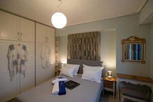 a bedroom with a bed with a towel on it at Lampetos Houses Molyvos in Mythimna +37 photos