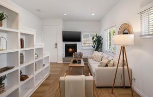 a living room with a white couch and a fireplace at Exclusive 2BD 3BA with Balcony Venice Beach in Los Angeles
