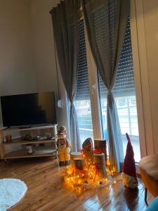 a living room with christmas decorations in front of a window at Helen's Art House in Pýli